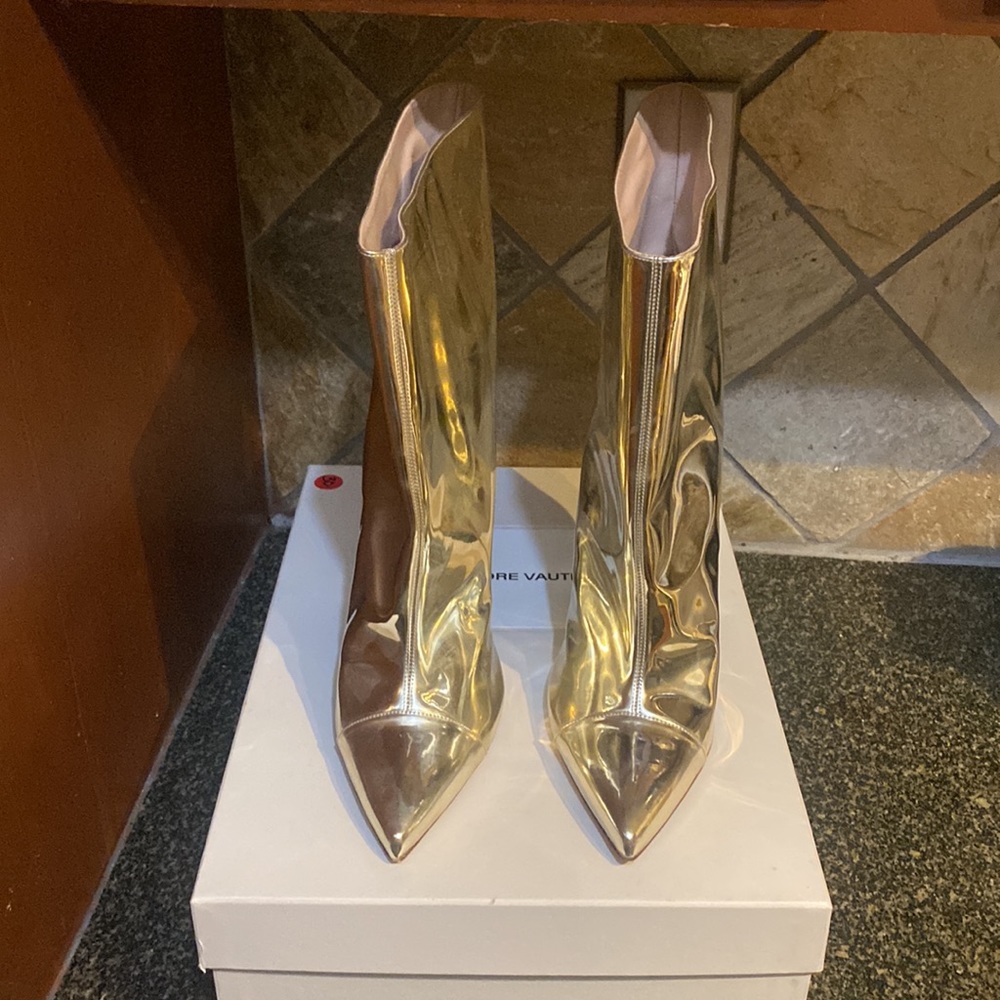 Alexandre Vauthier metallic boots with mirror finish and a refined pointed toe.